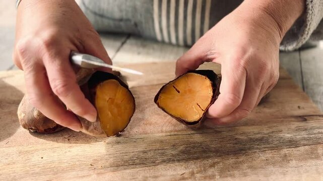 Cook chopping boiled sweet potato.
