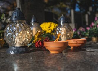 Lit Candle on a Grave Surrounded by Autumn Leaves During All Saints' Day in Poland