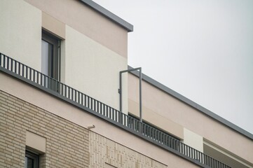 Modern apartment building exterior with balconies and brick facade