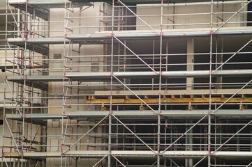 Scaffolding covering building under construction on overcast day