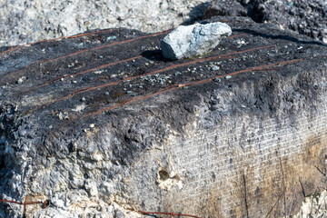 a damaged concrete block wrapped in metal wires