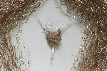 figurine of a ballerina girl on a Christmas tree. greeting card for ballerina