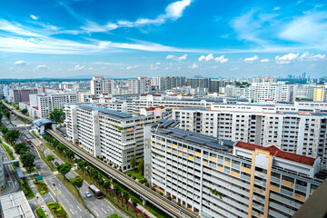 A landscape view of Singapore HDB housing with bright sky and clouds