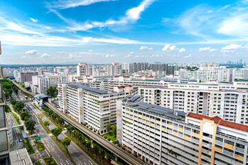 A landscape view of singapore HDB housing with bright sky and clouds