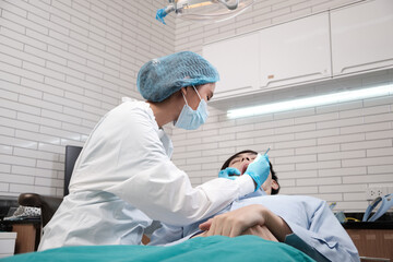 Asian female dentist examine young male patient teeth and toothache stomatology in dental clinic,...