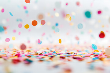 Abstract festive wallpaper with colorful falling confetti on white background. Background, illustration. Celebration, party, holiday.