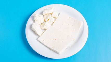 Sliced white cheese on plate 