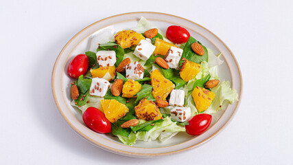 Salad with lettuce, cherry tomatoes, orange, almond and cheese