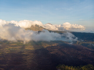 A stunning view of a mountain partially hidden by clouds.
