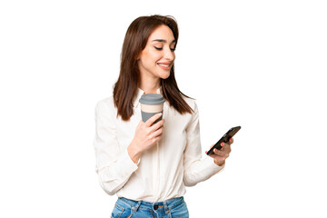 Young caucasian woman over isolated chroma key background holding coffee to take away and a mobile
