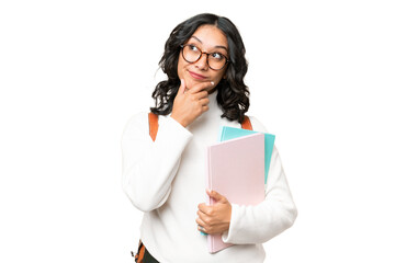 Young Argentinian student woman over isolated background and looking up