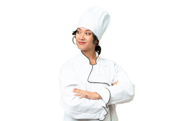 Young chef Argentinian woman over isolated background with arms crossed and happy