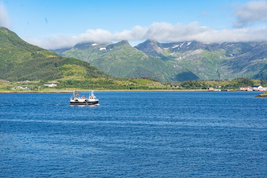Landscape of small ship in Gimsoystraumen strait in the Lofoten islands, Norway
