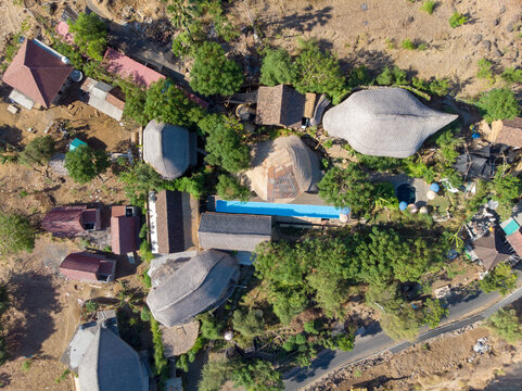 Aerial view of unique architectural structures surrounded by trees.