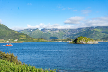 Obraz premium Landscape of small ship in Gimsoystraumen strait in the Lofoten islands, Norway