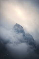 A mountain peak shrouded in mist and clouds.
