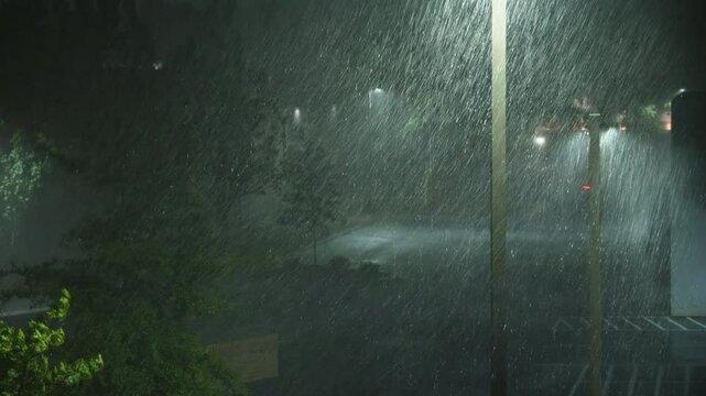 Hurricane Helene Strikes City With Strong Wind and Torrential Rain. Tropical Storm Helene South Carolina Greenville. Heavy Rain at Night on Street With Street Lights and Cars. Extreme Weather Events.