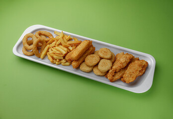 Fried snack for beer. Large plate of beer snacks: croutons, fried onion rings in batter, french fries, potato wedges