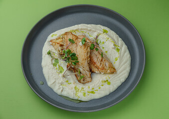 Sea bass with delicate creamy mashed potatoes and olive oil.