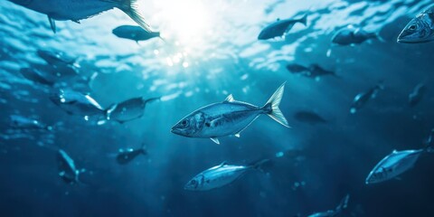 Fototapeta premium School of fish swimming underwater in blue ocean environment