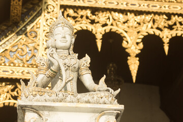 Fototapeta premium Thai white angel statue with lotus in temple