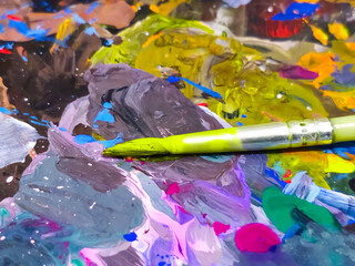 Tangerang, Indonesia - October 12, 2024: Paint brush for painting. With colorful oil artist paint palette board background. Oil paint brush.