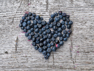 heart shaped berries on wooden background