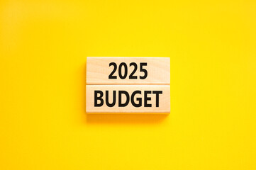 Naklejka premium Planning 2025 budget new year symbol. Concept words 2025 Budget on beautiful wooden blocks. Beautiful yellow background. Business 2025 budget new year concept. Copy space.