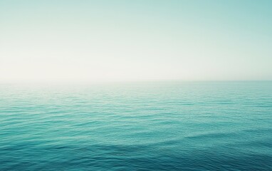 Obraz premium A serene view of calm ocean waters blending into a soft horizon, capturing the tranquility and beauty of nature in cool blue tones.