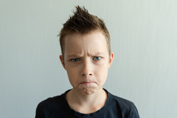 Portrait of a handsome teenage bad boy with stylish haircut, softbox lighting studio shot