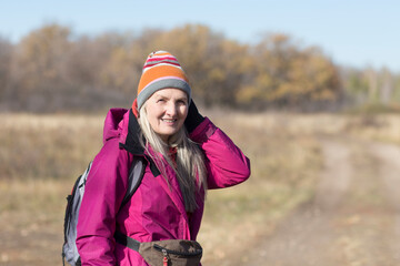 senior woman  with gray hair   walks in autumn outdoor. copy space. mental health. Slow life.  copy space