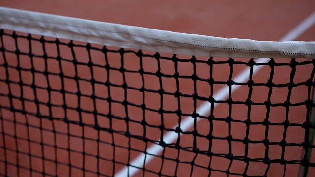 View of the tennis court.
Tennis court.
Tennis equipment on the court.
Tennis net stretched on the court