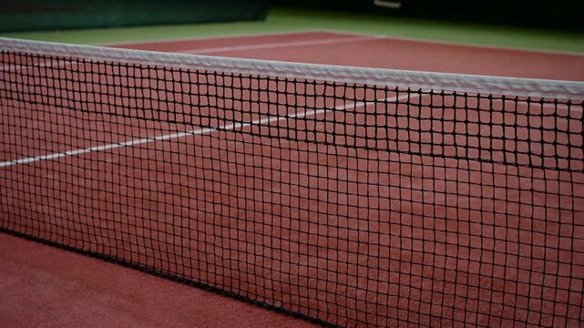 View of the tennis court.
Tennis court.
Tennis equipment on the court.
Tennis net stretched on the court