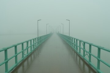 Fototapeta premium Pale green bridge with white road lines over turquoise water against a soft blue background