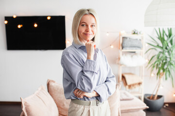 Portrait of Happy Middle Aged Woman standing in living room