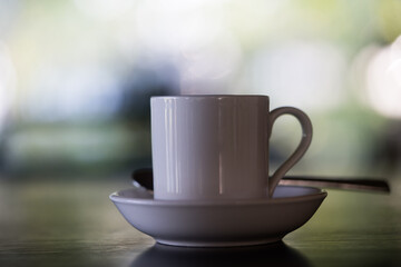 Morning cup of hot coffee with blur background