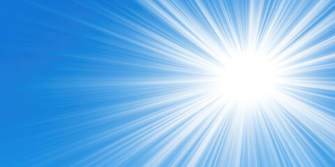 Radiant sunburst in clear blue sky with vibrant light rays