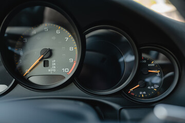 Dashboard instrument cluster displaying speed, RPM, and various indicators.