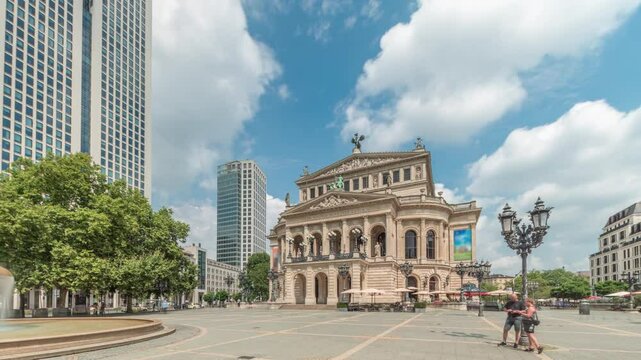 Hyperlapse of the Alte Oper (Old Opera) house in Frankfurt, a concert hall in Opernplatz. The square features a central fountain with people walking around, highlighting historic landmark timelapse