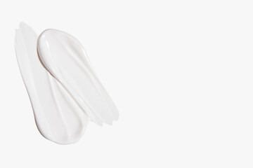 Composition of white cream smears on a light background. Skincare product, beauty textures.