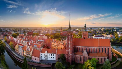 Obraz premium aerial drone view of old town buildings and the cathedral of st peter and paul the apostles and before sunset the sun s rays beautifully highlight the urban old architecture in legnica poland