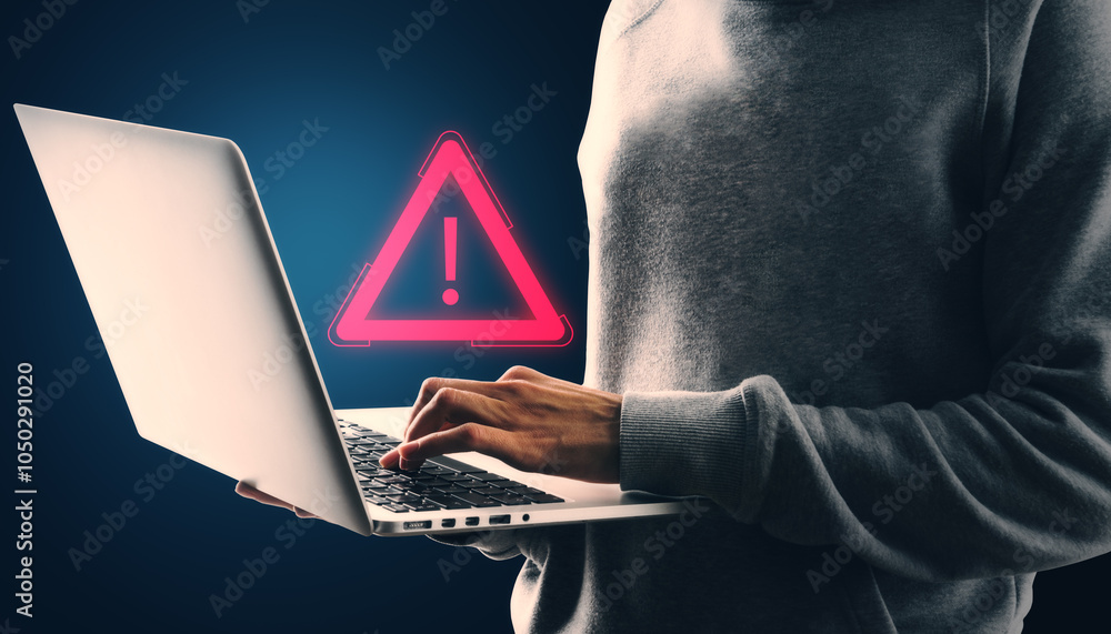Poster Person using laptop with red exclamation mark warning sign on dark background. Concept of digital error or attention.