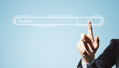 Hand touching virtual search bar on a digital interface with a magnifying glass icon, light blue...