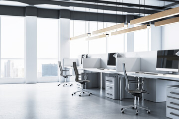 Modern office interior with desks, computers, and city view through large windows. 3D Rendering
