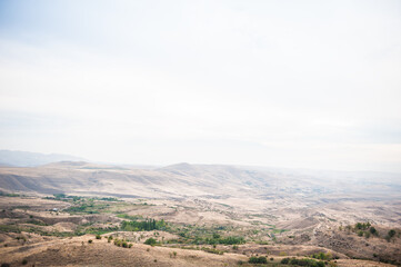 Majestic mountains of Armenia under a foggy sky filled with clouds, showcasing natural beauty