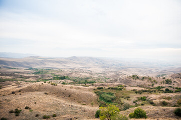 Majestic mountains of Armenia under a foggy sky filled with clouds, showcasing natural beauty