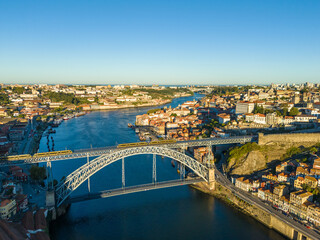 Fototapeta premium Porto City, Douro River and Dom Luis Bridge I with Trams in Morning. Aerial View. Portugal