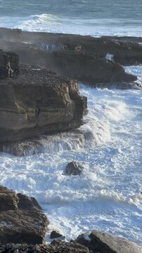 Portugal - Atlantic Ocean Waves hitting the rocky cliffs on the shores of Portugal