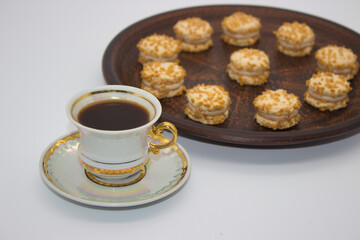 Cup of coffee with mini nut cookies
