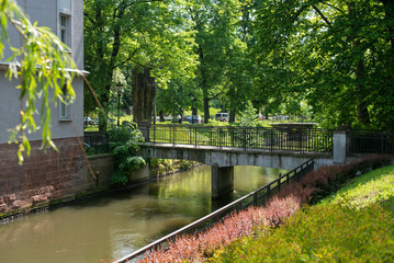 Water channels of the Nysa river in Klodzko, Poland, flowing around the historic town, with scenic views of medieval bridges and charming architecture.